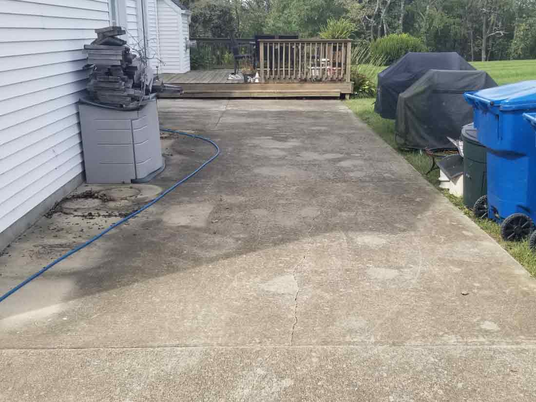 dirty driveway before being cleaned