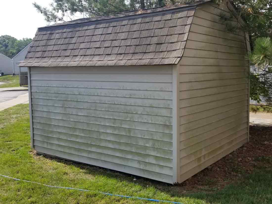 small shed with algae on side